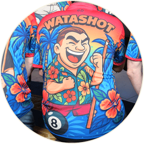 Two people wearing colorful shirts with cartoon characters and the words “WATASHOT" on one shirt and "ASHOT" on the other are sitting side by side. Description generated by AI
